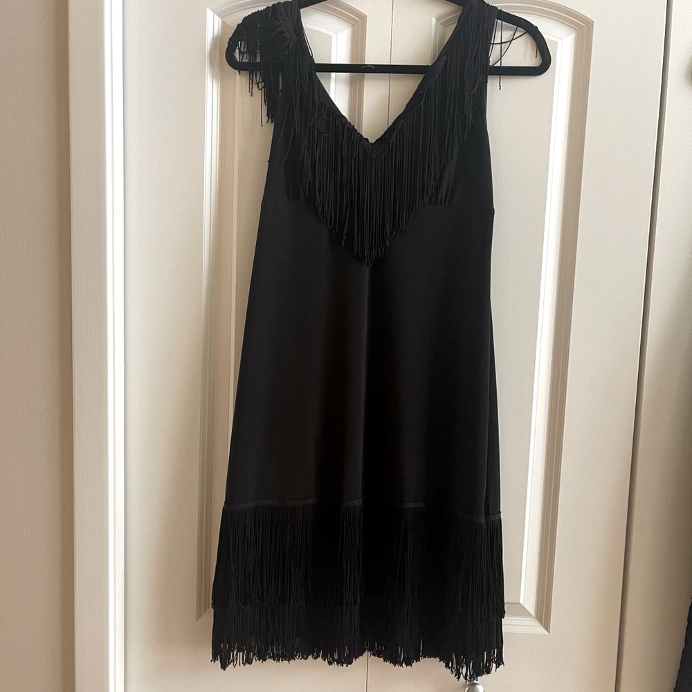 Mint condition black dress with fun fringes.